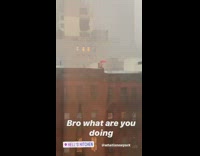 Shirtless guy in rain rooftop pink umbrella 