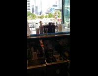 Girl blue bikini kneel ledge outside bar