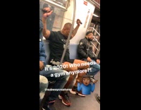 Man does arm workout exercise with resistance band on subway train