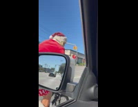 Filmer greet man in santa costume ride bike
