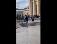 Woman black top dances at park stairs