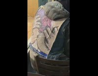 Guy wears custom painted denim vest table