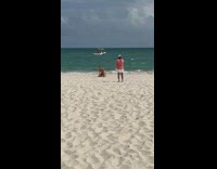 Woman in bikini tiktok dance at the beach