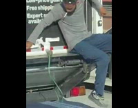 Guy Closes Back Door of Big Truck on Freeway 