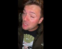 Guy inside club chugs cocktail 