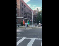 Two guys on stilts crosswalk green pants 