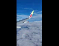 Rainbow shadows the wing of the plane