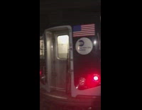 evacuated people on train helped by mta workers on track