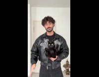 Man carries cat shows pet dance skills 