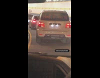 White car with honk if horny on windshield 