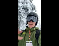 Skier shotguns Coors light beer while skiing down mountain