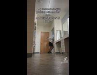 Woman in hoodie dancing with black cat 