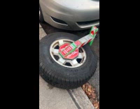 Car with violation removes tire with boot