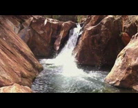 Guy does backflip off rock