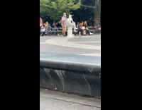 Guy talks to human statue street performer 