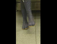 Person on subway train wearing boots with big toe thongs 
