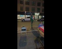 Man waving flag dances by street 