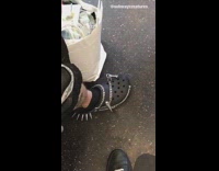 Guy wears black edgy spiky chain crocs on the subway train