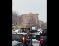 Forklift moves damaged car on the road