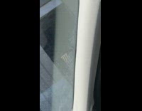 Guy in white mask and costume sits on chair on the street