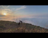 Guy play with dog on mountain clouds sunset