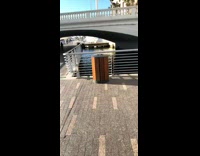 Girl climbs metal railing selfie over water 