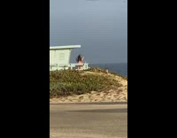 Bikini girl blue lifeguard tower parking lot