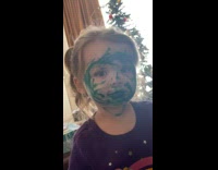 Little girl face colored in green marker 