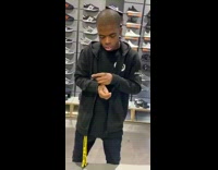 Guy standing in shoe store falls asleep