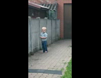 Boy handed a toy then threw it to the yard of their neighbor