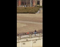 Blonde woman dances for video next to bench 