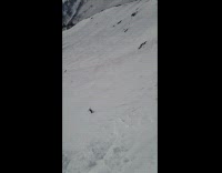 Skier tumbles down mountain after jumping off cliff