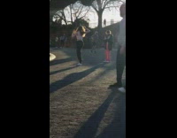 Girl wearing pink pants photographs friend park