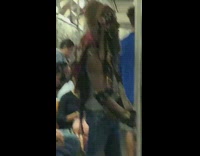 Man wears Native American headdress on subway train