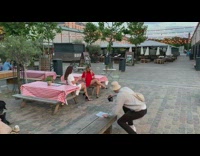 Two girls red white dress outdoor table