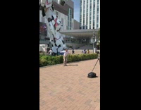 Guy sets up tripod and jumps for picture in front of giant robot 