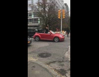man in red convertible car sit up dancing 