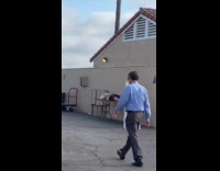 Man sleep over table beside bathroom building
