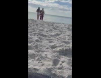 Guy santa costume selfie with woman beach