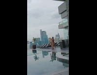Woman in bikini dances with rollerblades by the pool