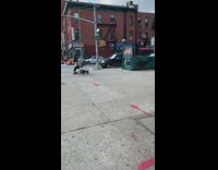 Woman pushes baby carriage stroller and rides hoverboard across street