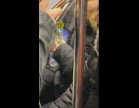 Woman eats bag of asparagus on subway train