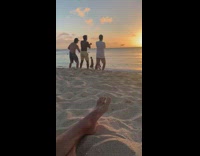Three guys dance beach drone sunset foot