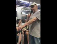 Old man white hat sings on karaoke machine in spanish on subway train