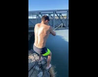 Guy swings on rope tied to bridge and does backflip 