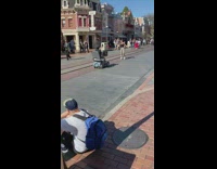 Woman walk backwards trolley cameraman disneyland street
