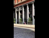 Girl pink leggings dance beside wall pillars