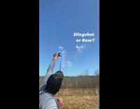 Guy hits chalk with slingshot bow arrow 