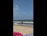 Woman blue bikini roll over towards beach