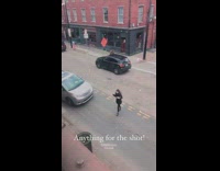 Car honks at girl photographing food street